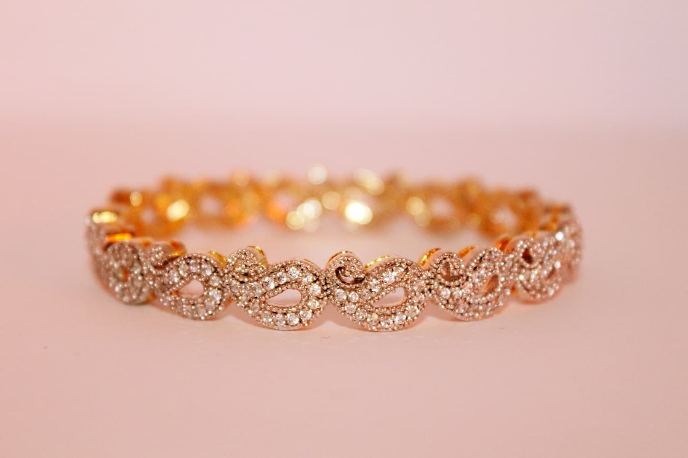 Rose-gold pavé bracelet on a pale background