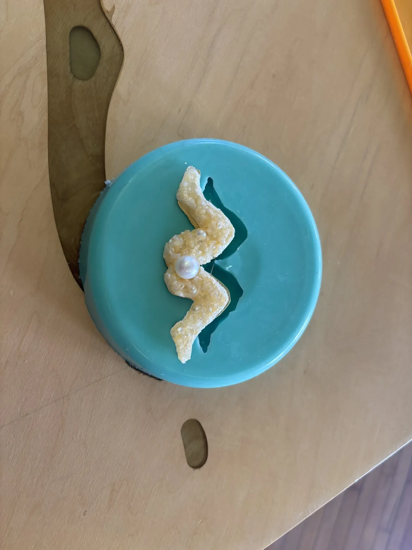 Pearl Brooch Next To Mold